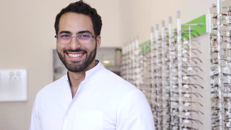 Optician-Doctor-Near-Showcase-With-Eyeglasses-At-Glasses-Shop