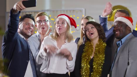 Happy-Businesspeople-Taking-Selfie-at-Christmas-Party