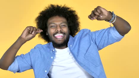 Excited-Afro-American-Man-Dancing-on-Yellow-Background