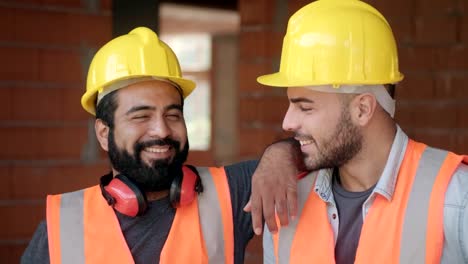 Happy-Construction-Workers-Smiling-At-Camera-In-New-Building