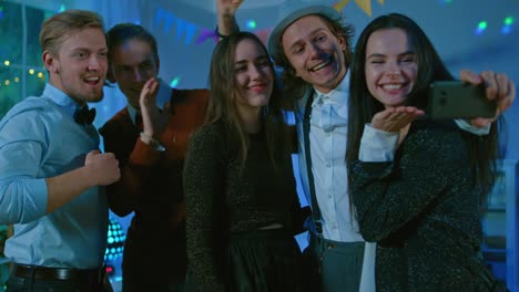 Happy-Group-of-Young-People-Taking-Collective-Selfie-at-the-Wild-House-Party.-Neon-Lights,-Disco-Ball-and-Funny-Costumes.