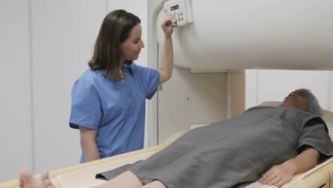 Portrait-Of-Friendly-Successful-Doctor-Smiling-At-Camera-During-MRI