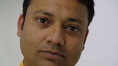 Close-up-of-an-Indian-man-looking-at-camera-in-a-sombre-mood