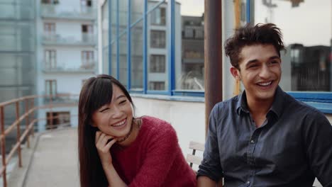 Young-friends-laughing-in-the-balcony