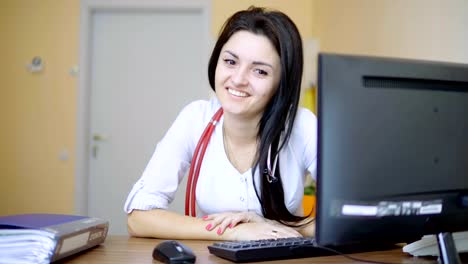 Female-doctor-laughing-in-the-office-while-working.-Healthcare-and-medicine-concept