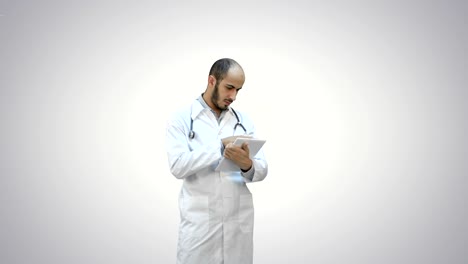 Male-doctor-using-digital-tablet-on-white-background