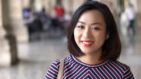 cerca-de-hermosa-mujer-China-sonriendo-a-la-cámara