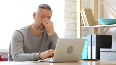 Tired-Sleeping-Middle-Aged-Man-on-Desk-in-Office