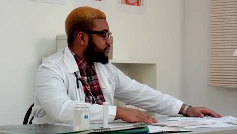 Serious-afro-american-male-doctor-listening-to-patient