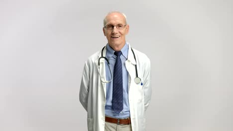 Elderly-doctor-smiling-and-crossing-his-arms