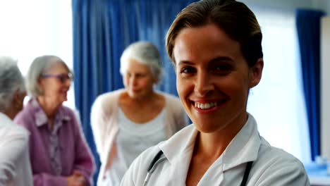 Portrait-of-female-doctor-standing-with-arms-crossed-4k