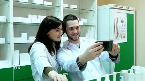 Divertido-equipo-de-farmacéutico-haciendo-fotos-selfie-en-farmacia