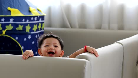 cute-baby-boy-happy-in-living-room-with-soft-pad-mattress-partition-limit-area-self-protection-in-family-home