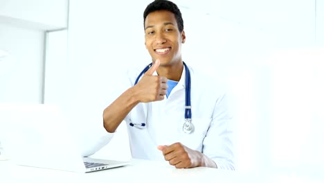 Thumbs-Up-by-Afro-American-Doctor-in-Clinic