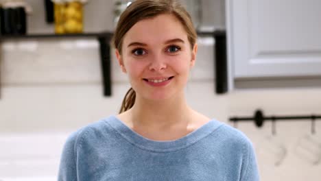 Portrait-of-Smiling-Positive-Woman-at-Home