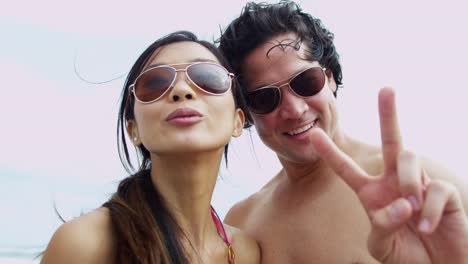 Portrait-Asian-Chinese-young-couple-sunglasses-filming-selfie