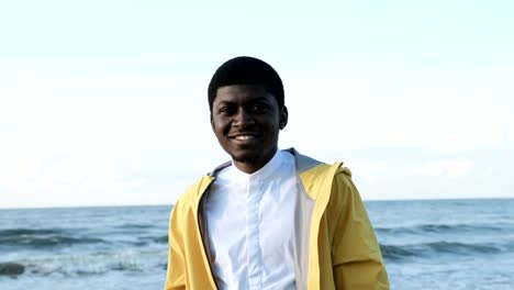 Face-portrait-of-smiling-african-man-on-coast