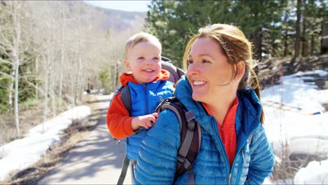 Portrait-Caucasian-mum-carrying-baby-son-back-carrier