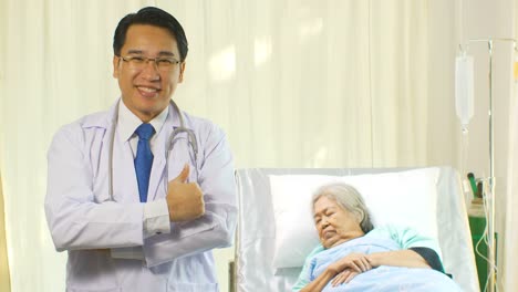 Doctor-with-stethoscope-checking-patient's-blood-pressure-of-old-woman-on-the-bed-Doctor-with-stethoscope-checking-patient's-blood-pressure-of-old-woman-on-the-bed-Portrait-of-smiling-doctors-standing-in-a-hospital-room