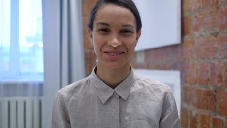 Portrait-of-Smiling-Hispanic-Frau-sitzt-im-Büro