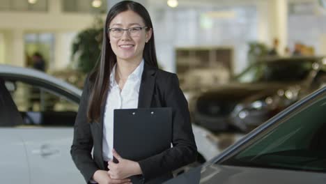 Saleswoman-Posing-at-Car-Dealership