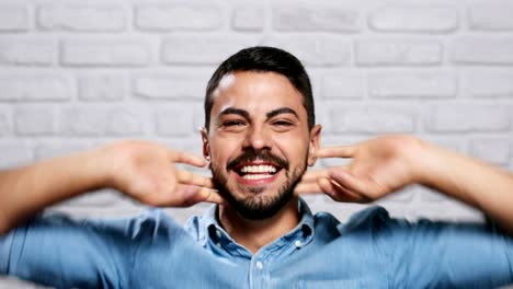 Facial-Expressions-Of-Young-Beard-Man-On-Brick-Wall