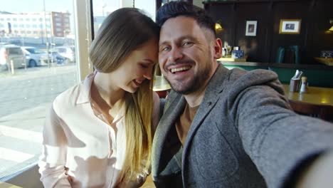 Engaged-Couple-Posing-for-Selfie-on-Date