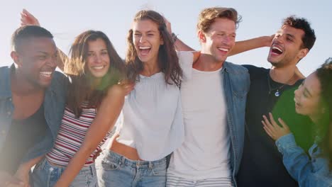 Portrait-Of-Friends-Relaxing-Together-On-Summer-Beach-Vacation