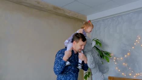 Young-father-spinning-his-happy-daughter