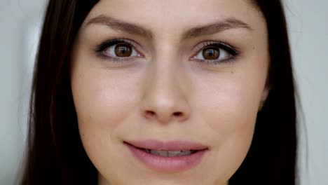 Close-Up-of-Smiling-Face-of-Young-Woman-Looking-at-Camera