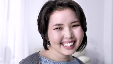 Portrait-of-young-happy-asian-brunette-girl,-looking-at-camera,-smiling-face,-laughing.-50-fps