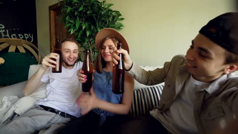 Point-of-view-shot-of-cheerful-friends-taking-selfie-with-beer-bottles,-posing-and-smiling,-laughing-and-gesturing.-Friendship-and-happy-young-people-concept.
