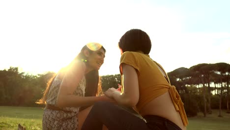 Two-Young-Happy-young-women-Talking-At-The-Park