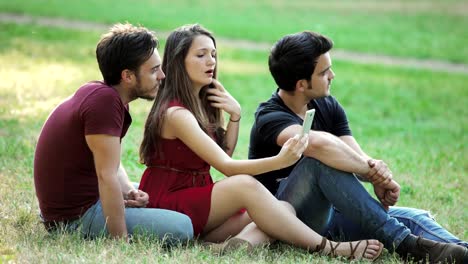 drei-lächelnden-jungen-Freunde-nehmen-Selfie-im-park