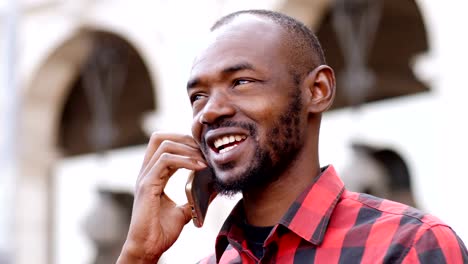 happy-black--man-talking-on-the-phone---close-up-portrait