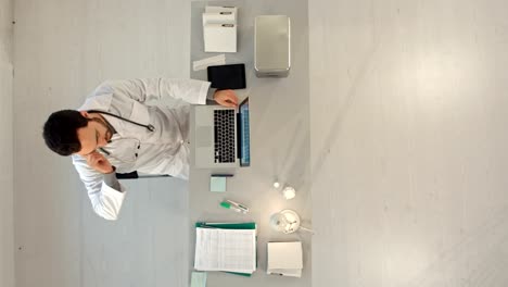 Doctor-with-a-cellphone-and-laptop-computer.-Top-view