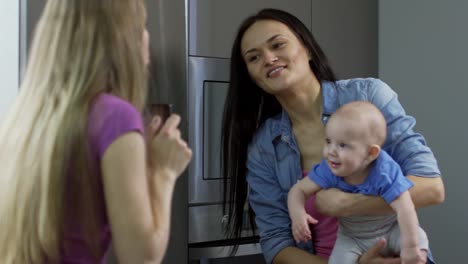 Mother-Taking-Picture-of-Female-Partner-with-Baby