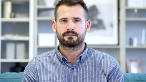 Portrait-of-Serious-Adult-Man-Looking-at-Camera