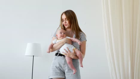 happy-loving-family.-mother-playing-with-her-baby-in-the-bedroom