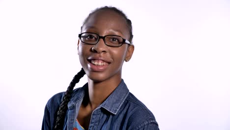 Joven-mujer-afroamericana-con-encanto-en-gafas-sonriendo-a-cámara,-aislada-sobre-fondo-blanco,-feliz-y-alegre