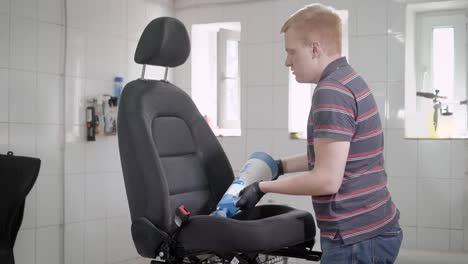 Man-sprinkling-car-seat-from-pulveriser