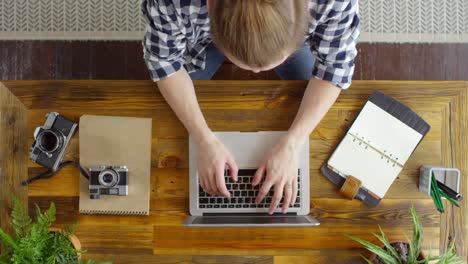 Top-View-of-Freelancer-Working-on-Laptop