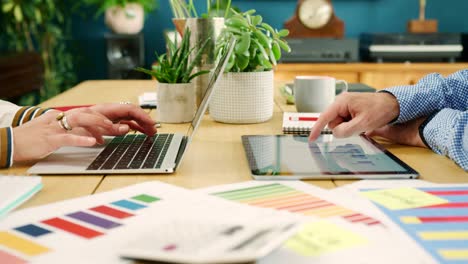 Business-Colleagues-Checking-Over-Financial-Data-In-Their-Office