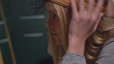 Close-up-of-two-young-women-trying-on-hats-in-a-store