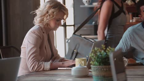 Female-Customer-In-Coffee-Shop-Using-Laptop-Shot-On-R3D