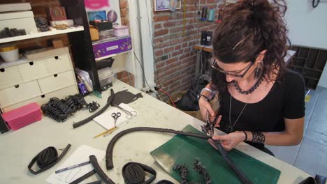 Young-eco-jewelry-maker-creating-artwork-in-her-atelier