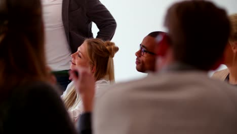 Multi-ethnic-business-team-members-attending-presentation-in-meeting-room