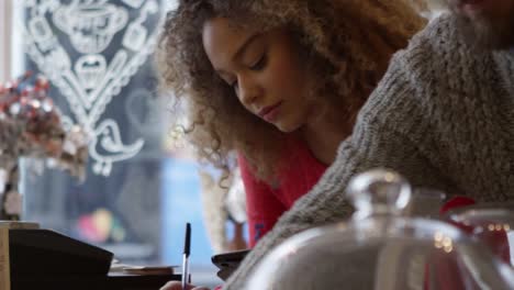 Young-Couple-Working-In-Coffee-Shop-Shot-On-R3D