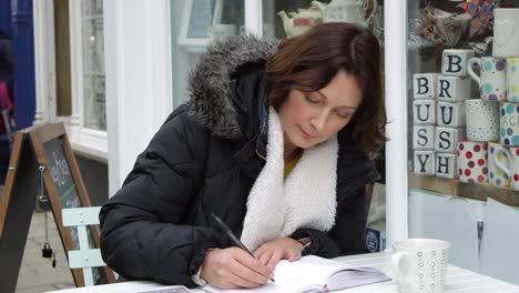 Mature-Woman-Sitting-Outside-Cafe-Whilst-Working-Shot-On-R3D