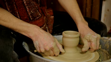 Professional-male-potter-working-in-workshop,-studio